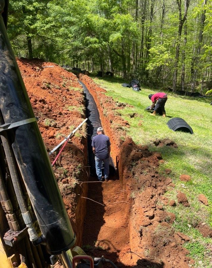 Drain field pipe being installed in a trench